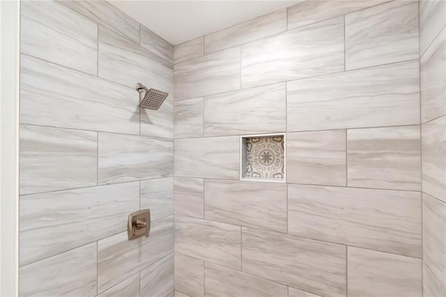 bathroom with a tile shower