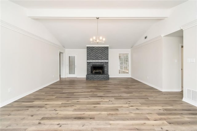 unfurnished living room featuring vaulted ceiling with beams, a chandelier, wood-type flooring, and a brick fireplace