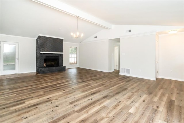 unfurnished living room featuring a brick fireplace, ornamental molding, a chandelier, hardwood / wood-style floors, and vaulted ceiling with beams