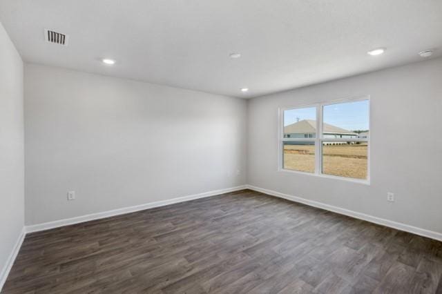 empty room with dark wood-type flooring