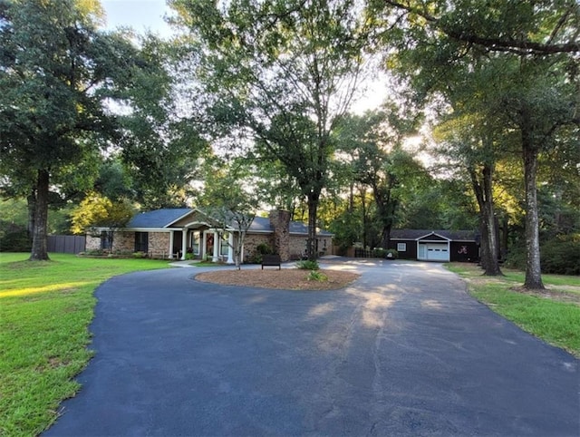 3661 Leroy Stevens Rd, Mobile, AL 36619 - ranch-style house featuring driveway, stone siding, fence, a front yard, and a garage
