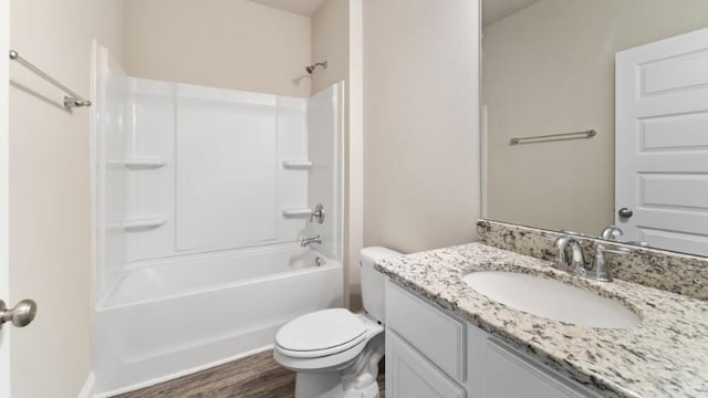 full bathroom featuring vanity, hardwood / wood-style flooring, shower / bathtub combination, and toilet