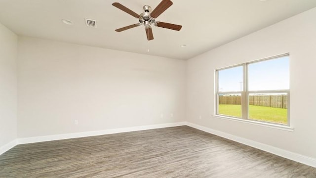 spare room featuring dark hardwood / wood-style flooring and ceiling fan