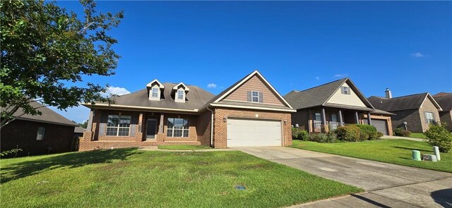 2509 Hedgerow Dr, Mobile, AL 36695 - craftsman inspired home featuring brick siding, driveway, a front lawn, and a garage