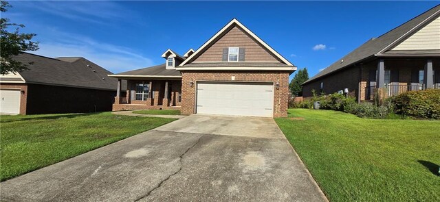 2509 Hedgerow Dr, Mobile, AL 36695 - view of front of property featuring a garage, brick siding, a front yard, and concrete driveway