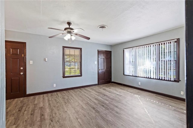 unfurnished room with ceiling fan and wood-type flooring