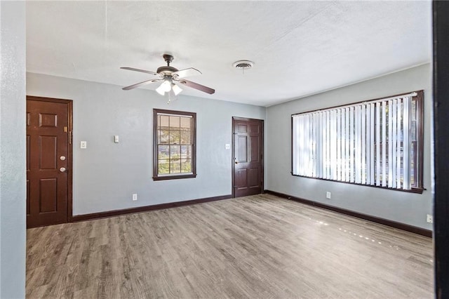 spare room with wood-type flooring and ceiling fan