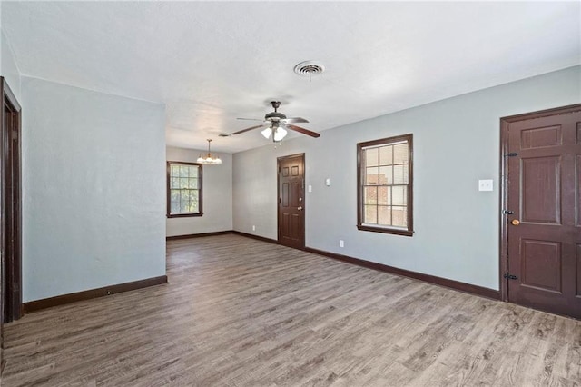 entryway featuring wood-type flooring and ceiling fan with notable chandelier