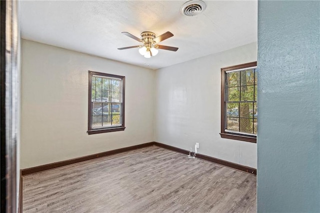 empty room with ceiling fan and hardwood / wood-style floors