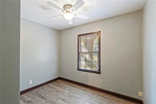 spare room featuring light hardwood / wood-style flooring and ceiling fan