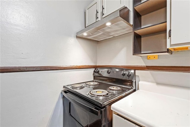 kitchen with black / electric stove and white cabinets