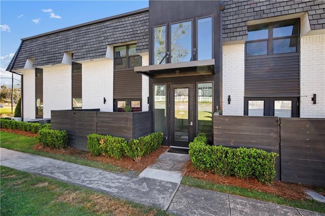3655 Old Shell Rd Unit 121, Mobile, AL 36608 - view of front facade with brick siding, french doors, and mansard roof