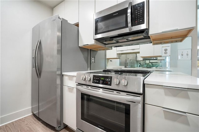 3655 Old Shell Rd Unit 121, Mobile, AL 36608 - kitchen with appliances with stainless steel finishes, light countertops, and white cabinetry