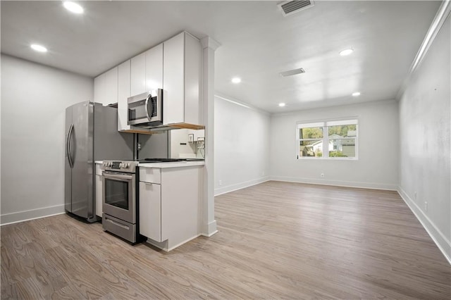 3655 Old Shell Rd Unit 121, Mobile, AL 36608 - kitchen featuring appliances with stainless steel finishes, white cabinets, light wood-style flooring, recessed lighting, and crown molding