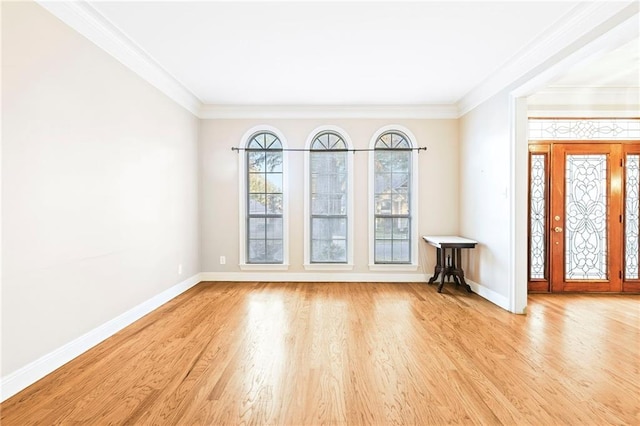 spare room featuring light hardwood / wood-style flooring and crown molding