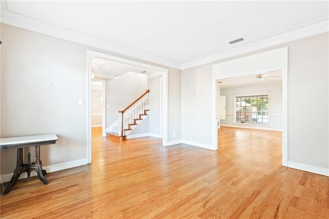 unfurnished room with ceiling fan, light wood-type flooring, and ornamental molding