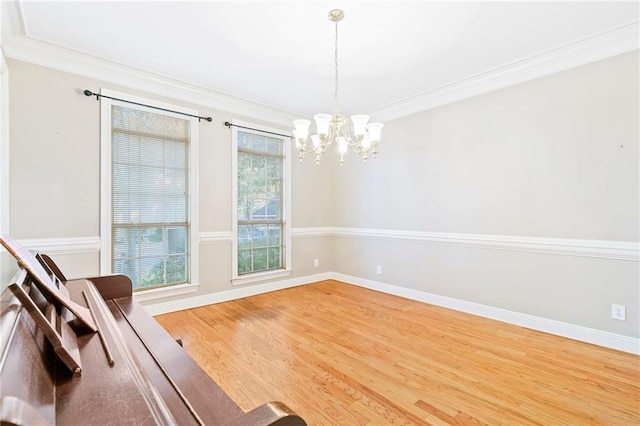 interior space with a chandelier, hardwood / wood-style floors, and crown molding