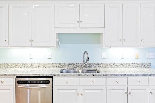 kitchen featuring stainless steel dishwasher, light stone counters, white cabinetry, and sink