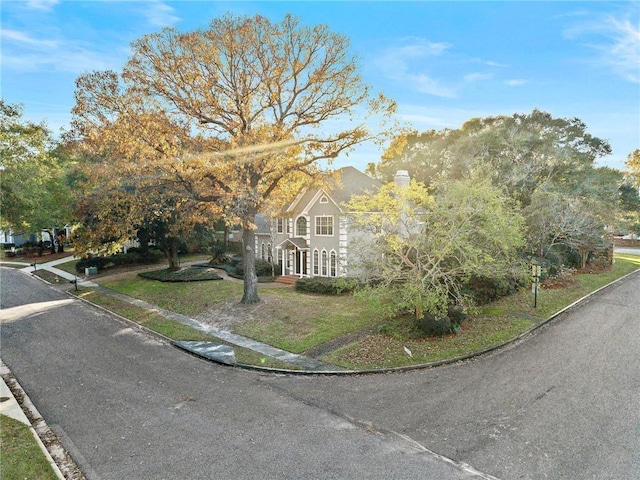 view of front of property featuring french doors and a front lawn