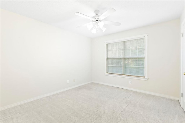 empty room featuring light colored carpet and ceiling fan