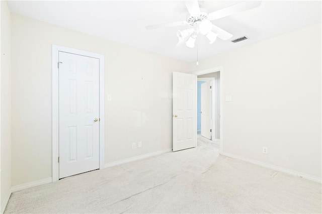 carpeted spare room with ceiling fan