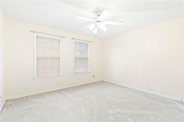 empty room featuring light carpet and ceiling fan