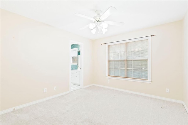 unfurnished room with ceiling fan and light colored carpet