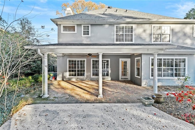 back of house with ceiling fan and a patio area