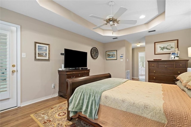 1045 Cross Gates Pl, Mobile, AL 36609 - bedroom featuring a tray ceiling, wood finished floors, ceiling fan, and recessed lighting
