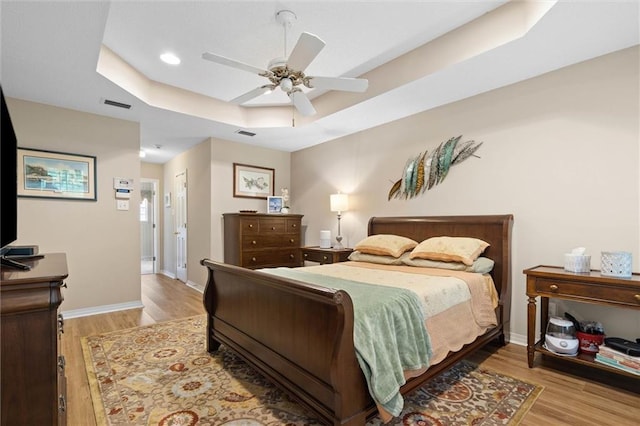 1045 Cross Gates Pl, Mobile, AL 36609 - bedroom featuring a raised ceiling, wood finished floors, a ceiling fan, and recessed lighting