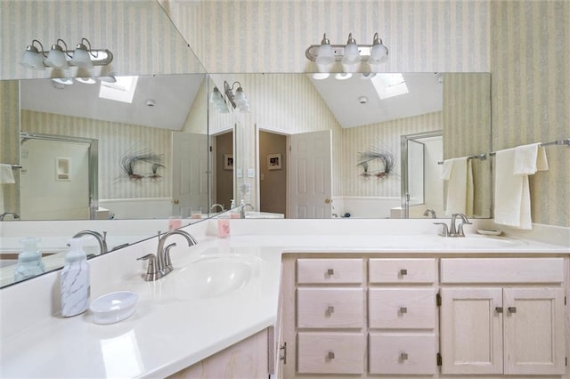 1045 Cross Gates Pl, Mobile, AL 36609 - full bathroom featuring a skylight, wallpapered walls, double vanity, and lofted ceiling