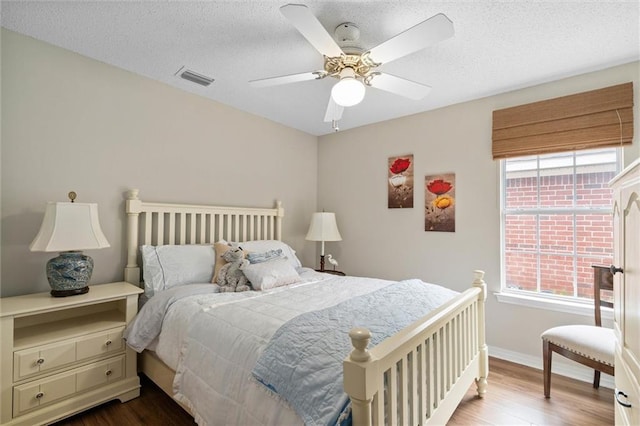 1045 Cross Gates Pl, Mobile, AL 36609 - bedroom featuring wood finished floors, a textured ceiling, and ceiling fan