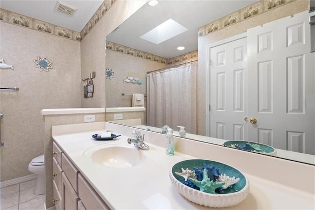 1045 Cross Gates Pl, Mobile, AL 36609 - full bathroom featuring a skylight, vanity, tile patterned flooring, and a shower with shower curtain