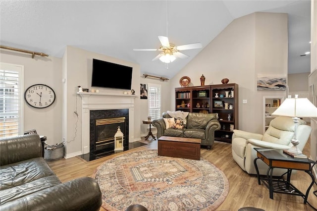 1045 Cross Gates Pl, Mobile, AL 36609 - living area with lofted ceiling, wood finished floors, ceiling fan, and a premium fireplace