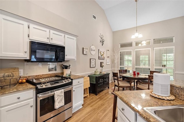1045 Cross Gates Pl, Mobile, AL 36609 - kitchen featuring stainless steel range, black microwave, white cabinetry, pendant lighting, and light stone countertops