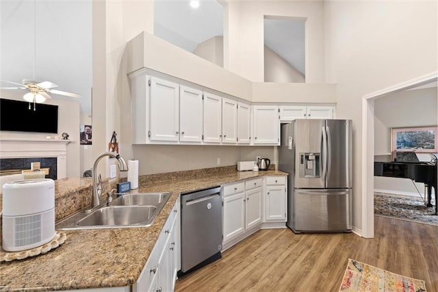1045 Cross Gates Pl, Mobile, AL 36609 - kitchen featuring stainless steel appliances, high vaulted ceiling, a ceiling fan, white cabinets, and light wood-type flooring