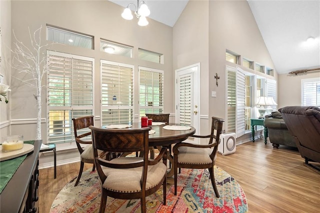 1045 Cross Gates Pl, Mobile, AL 36609 - dining area with high vaulted ceiling, light wood-type flooring, and a chandelier
