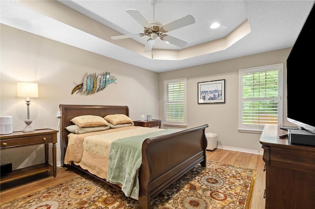 1045 Cross Gates Pl, Mobile, AL 36609 - bedroom with a raised ceiling, light wood-type flooring, a ceiling fan, and recessed lighting