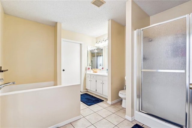 bathroom featuring vanity, tile patterned floors, a textured ceiling, and walk in shower