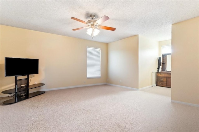 living room with ceiling fan, light carpet, and a textured ceiling