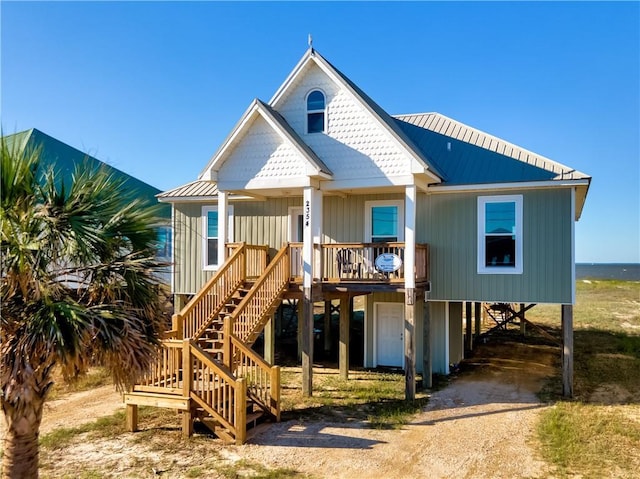 2354 Island Shores Dr, Dauphin Island, AL 36528 - back of property with a carport, driveway, covered porch, and stairs