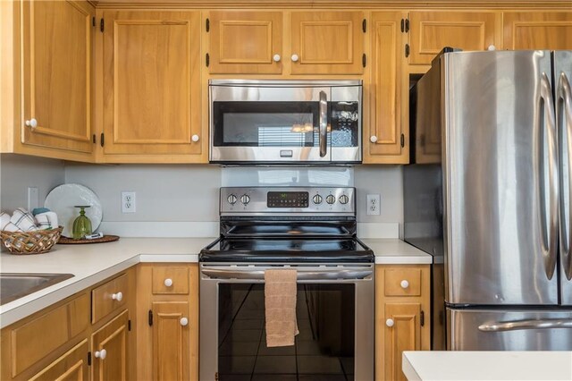 2354 Island Shores Dr, Dauphin Island, AL 36528 - kitchen featuring brown cabinetry, light countertops, and appliances with stainless steel finishes