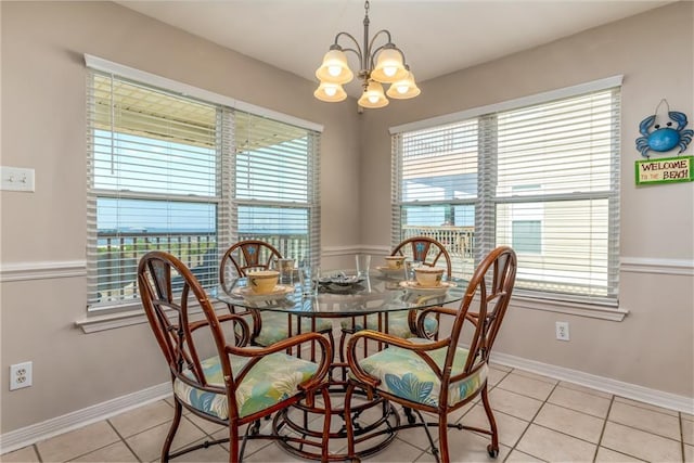 2354 Island Shores Dr, Dauphin Island, AL 36528 - dining space with a wealth of natural light, light tile patterned floors, and an inviting chandelier