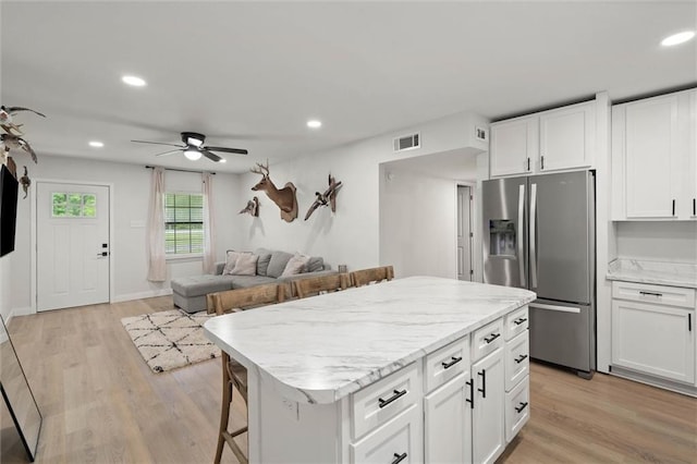 254 Fairford Rd, Calvert, AL 36513 - kitchen with stainless steel fridge, recessed lighting, ceiling fan, white cabinetry, and light wood-style flooring