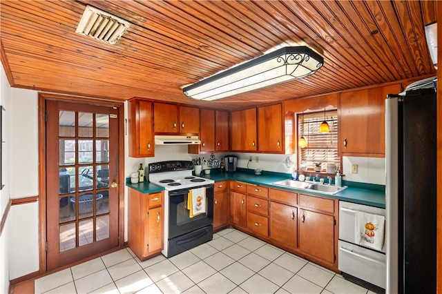 kitchen featuring stainless steel fridge, light tile patterned floors, white range with electric cooktop, dishwasher, and sink