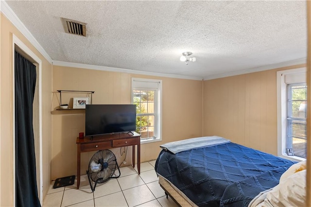 tiled bedroom with crown molding and a textured ceiling