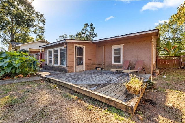 back of house featuring a wooden deck