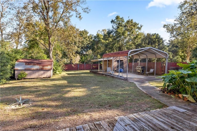 view of yard with an outdoor structure, a patio, and a carport