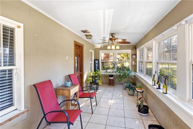 sunroom featuring ceiling fan