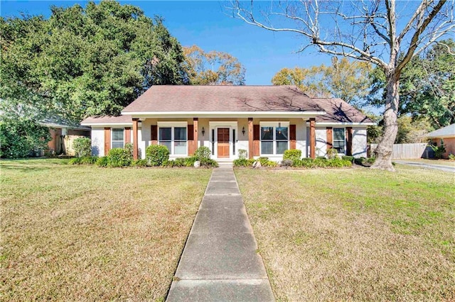 single story home featuring covered porch and a front yard